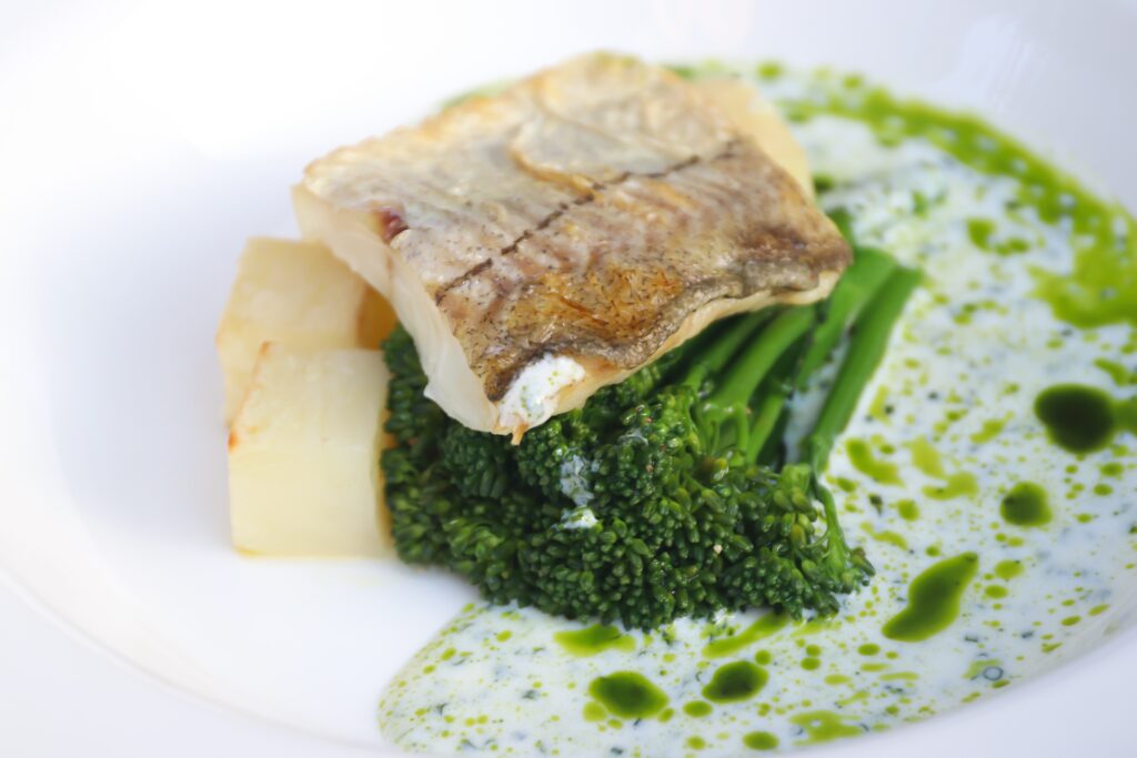 A plate of fish, potato and brocollini